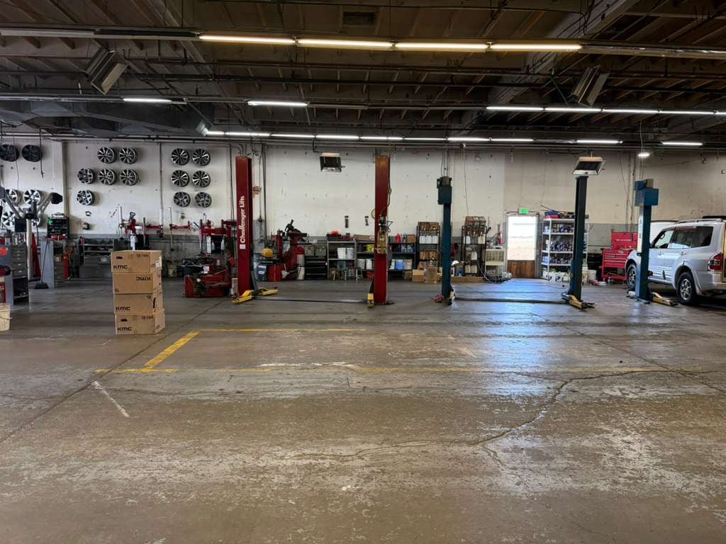 Shop bays with multiple 2-post lifts and KMC wheel boxes